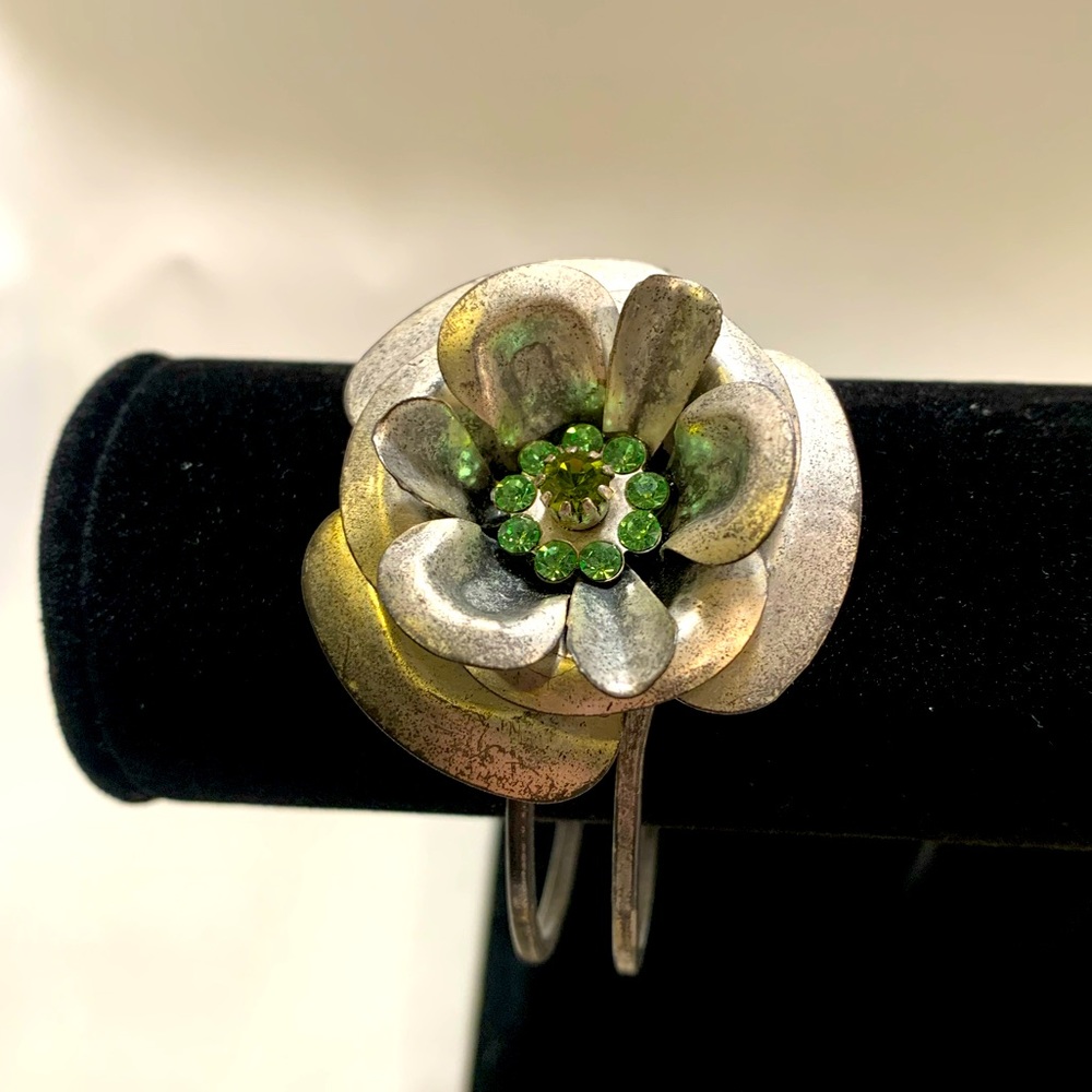 Silver metal banded, metal flower and green jewels